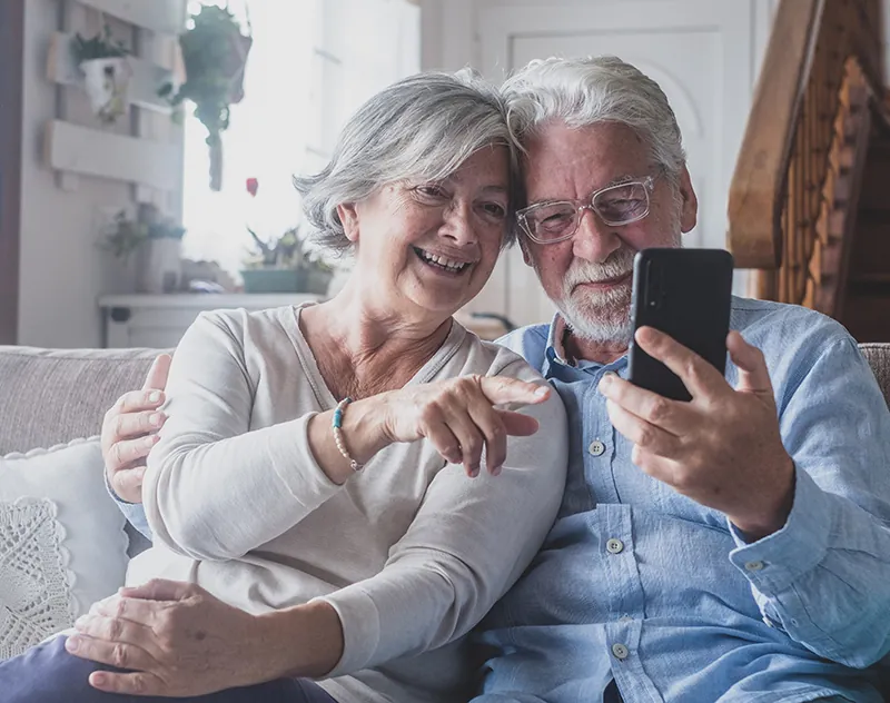 Older couple looking at a phone together