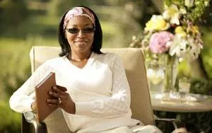 Woman reading outdoors in Transitions lenses